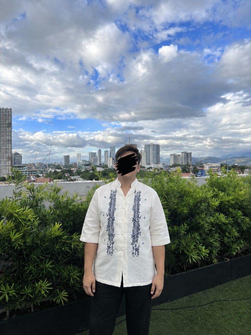 White Barong Tagalog with Blue Embroidery (Category: Formal Shirts) located in Manila. Submitted by macchi1216 (Listing ID 1458698959, Image 2). Description: - Classic white Barong Tagalog - Intricate blue embroidery on front panels - Mandarin collar with pearl button closure - Lightweight fabric for comfort - Ideal for formal events and cultural celebrations - Sharp, traditional look.