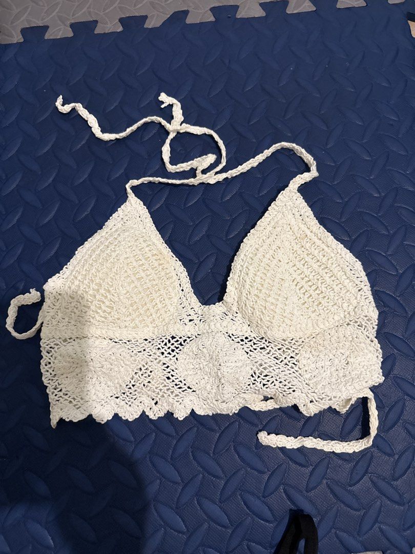 White Crochet Halter Neck Bralette Top (Category: Sleeveless) located in Makati City. Submitted by malcolmkenji (Listing ID 1460217965, Image 1). Description: - White crochet bralette - Halter neck with adjustable ties - Intricate crochet pattern along the hem - Versatile: great for layering or wearing solo - Ideal for beach days, festivals, or casual wear - Offers a custom fit with adjustable ties.