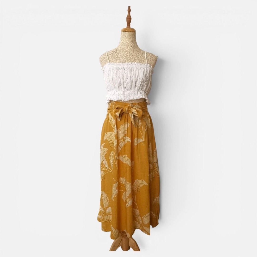 Mustard Leaf Print Midi Skirt (Category: Skirts) located in Mandaue City. Submitted by stylefigjam (Listing ID 1460237634, Image 1). Description: - Mustard yellow midi skirt with bold leaf print - Skirt features a tie waist - Garterized waistline - Ideal for beach vacations or summer outings *top not included.