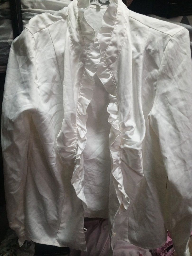 White Ruffled Blouse (Category: Blouses) located in Manila. Submitted by nannotk (Listing ID 1460150045, Image 1). Description: - White long-sleeved blouse - Ruffle detailing down the front - Button closure - Estimated size: Medium - Versatile: dress up or down - Condition: Good.