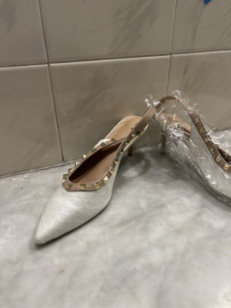 White Studded Pointed Toe Slingback Heels (Category: Heels) located in Quezon City. Submitted by natalie.ta (Listing ID 1460270834, Image 3). Description: - Stylish white slingback heels - Pointed toe design - Textured finish (possibly snakeskin) - Elegant gold-tone stud trim - Textured sole for enhanced grip - Perfect for a chic and sophisticated look.