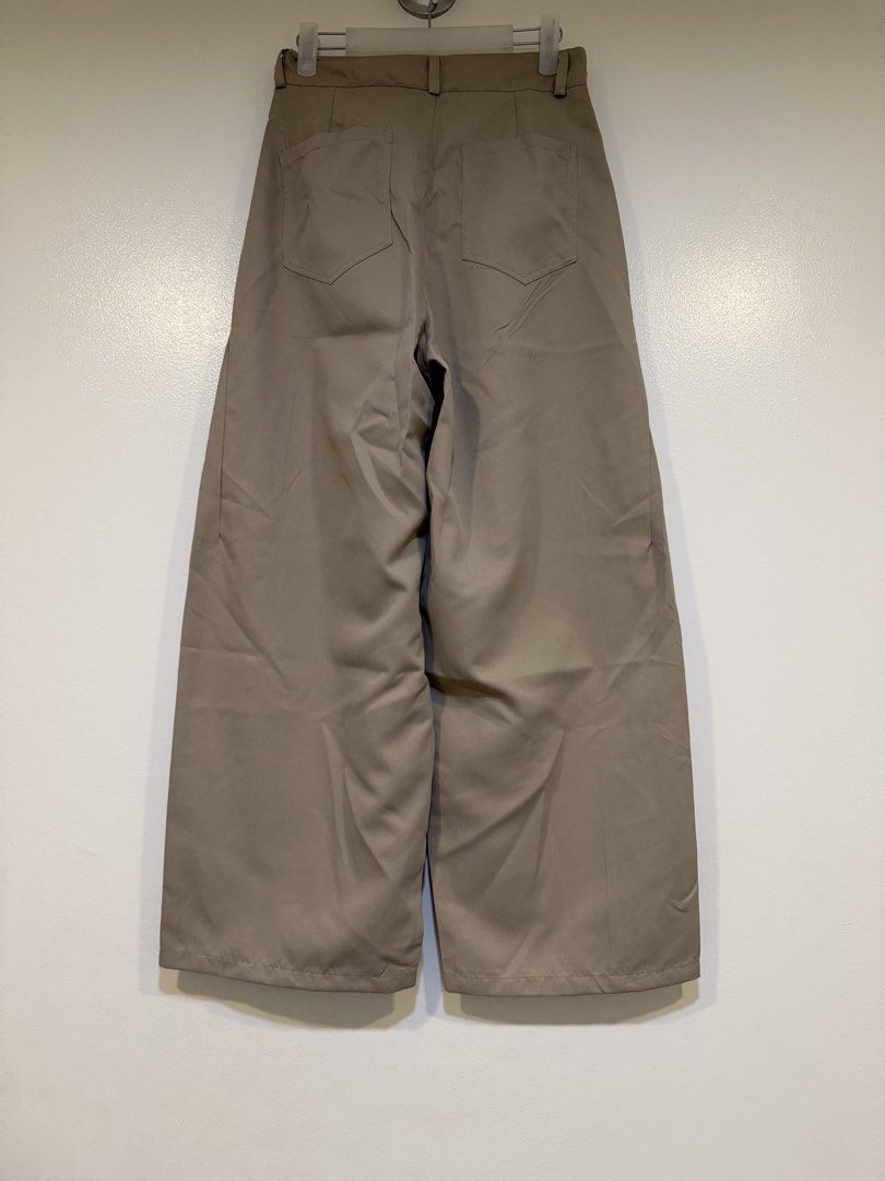 Wide Leg Pants Size S Beige (Category: Other Bottoms) located in Mandaluyong City. Submitted by closet.me (Listing ID 1460237042, Image 2). Description: - Beige wide leg pants - Size S - Button and zip closure - Front and back pockets - Versatile for casual or dressed-up outfits - Comfortable fit.