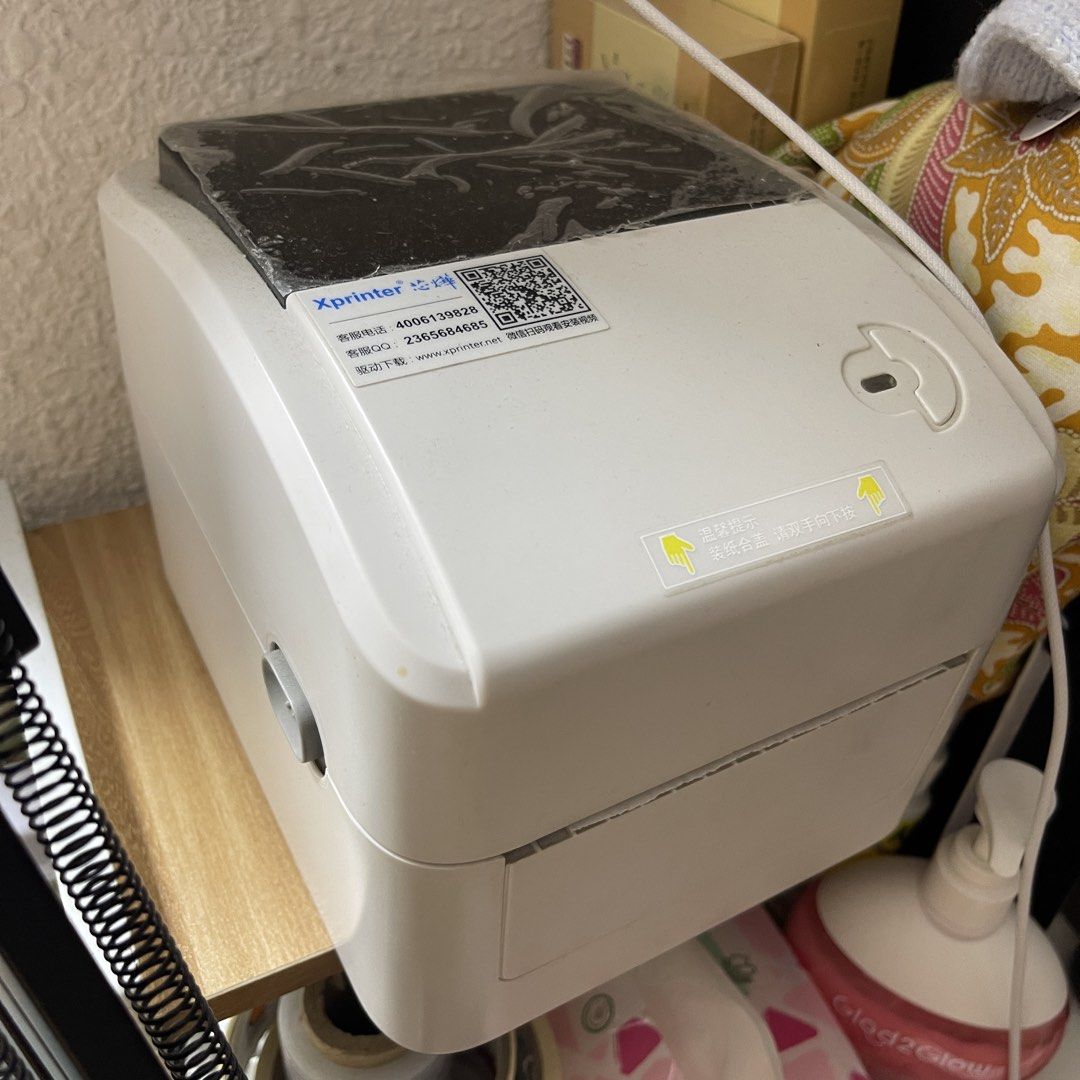 Xprinter Label Printer (Category: Printers, Scanners & Copiers) located in Johor Bahru. Submitted by mrjames. (Listing ID 1460290738, Image 1). Description: - White and compact Xprinter label printer - Protective film still on top - Includes customer service contact details - Website provided for driver downloads - Ideal for printing all types of labels - Ready for its new home.