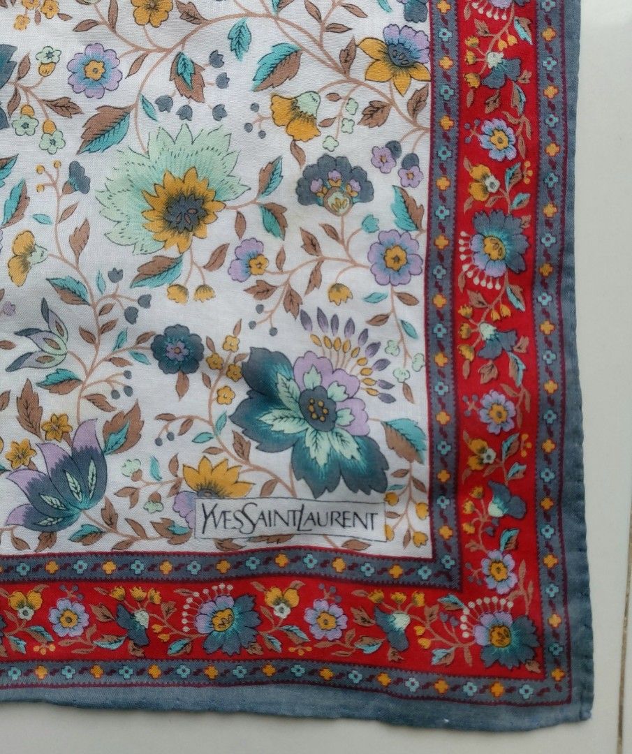Yves Saint Laurent handkerchief (Category: Scarves) located in Lapu Lapu. Submitted by agnesapm_29813 (Listing ID 1460250911, Image 3). Description: - Vintage Yves Saint Laurent handkerchief - Measurements: 17 inches x 17 inches - Beautiful all-over floral print - Accents of red, blue, and green - Red and grey patterned border - Versatile accessory for bags or neckwear.