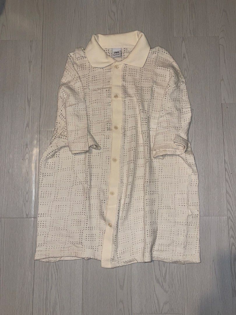 Zara Cream Textured Button-Up Shirt (Category: Tshirts & Polo Shirts ) located in San Juan City. Submitted by shop.wels (Listing ID 1460129341, Image 3). Description: - Cream-colored Zara shirt - Textured cotton fabric - Relaxed fit - Full button-up front with collar - Estimated size: US Large - Ideal for a minimalist aesthetic - Versatile: pair with trousers or shorts.