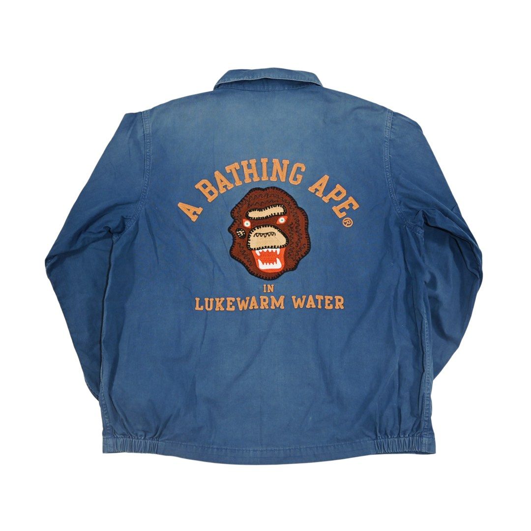 A Bathing Ape Navy Jacket (Category: Coats, Jackets and Outerwear) located in Quezon City. Submitted by jwinprince (Listing ID 1460501315, Image 2). Description: A Bathing Ape Navy Jacket Size: M Length: 26 Width: 22 Fabric shows visible overall wear and natural fading consistent with use. Tear present on the sleeve cuffs. From the Nigo led years, when BAPE operated on scarcity and cult following rather than mass production..