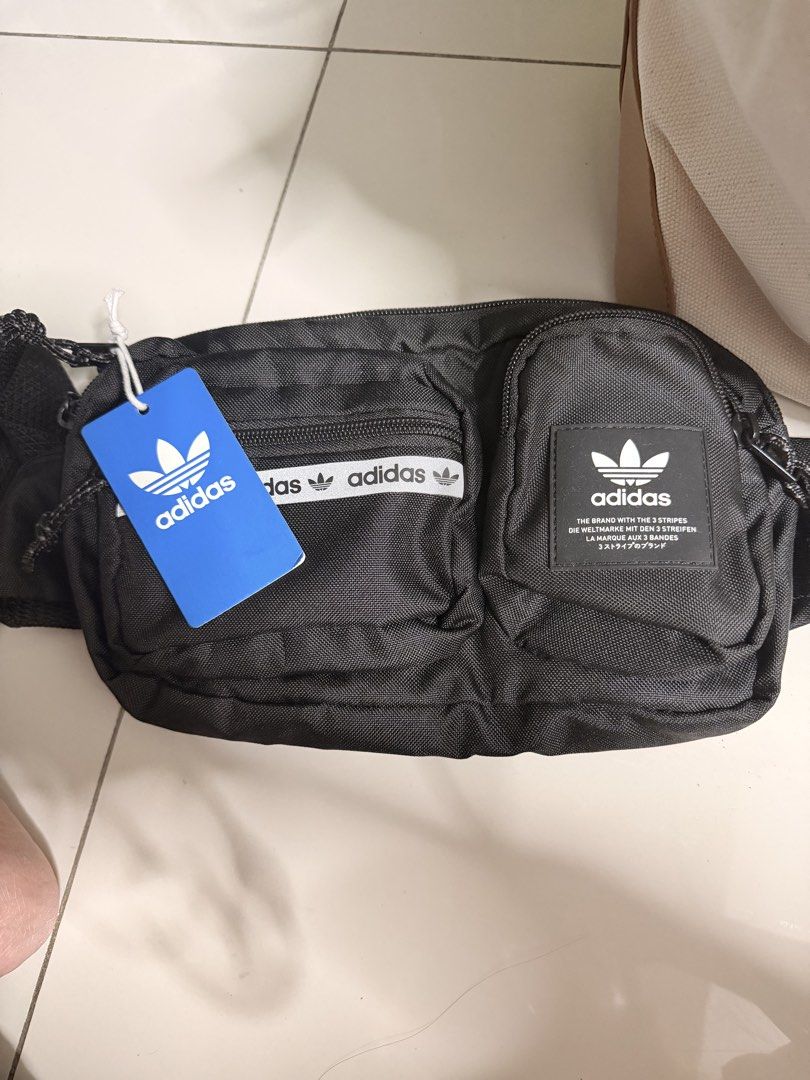 Adidas Waist Bag Black (Category: Belt bags, Clutches and Pouches) located in Rizal. Submitted by macristina33105 (Listing ID 1460308981, Image 1). Description: - Authentic Black Adidas Waist Bag - Multiple zippered compartments for secure storage - Comes with original tags attached - Versatile styling: wear around the waist or across the body - Ideal for everyday use, errands, or travel adventures.