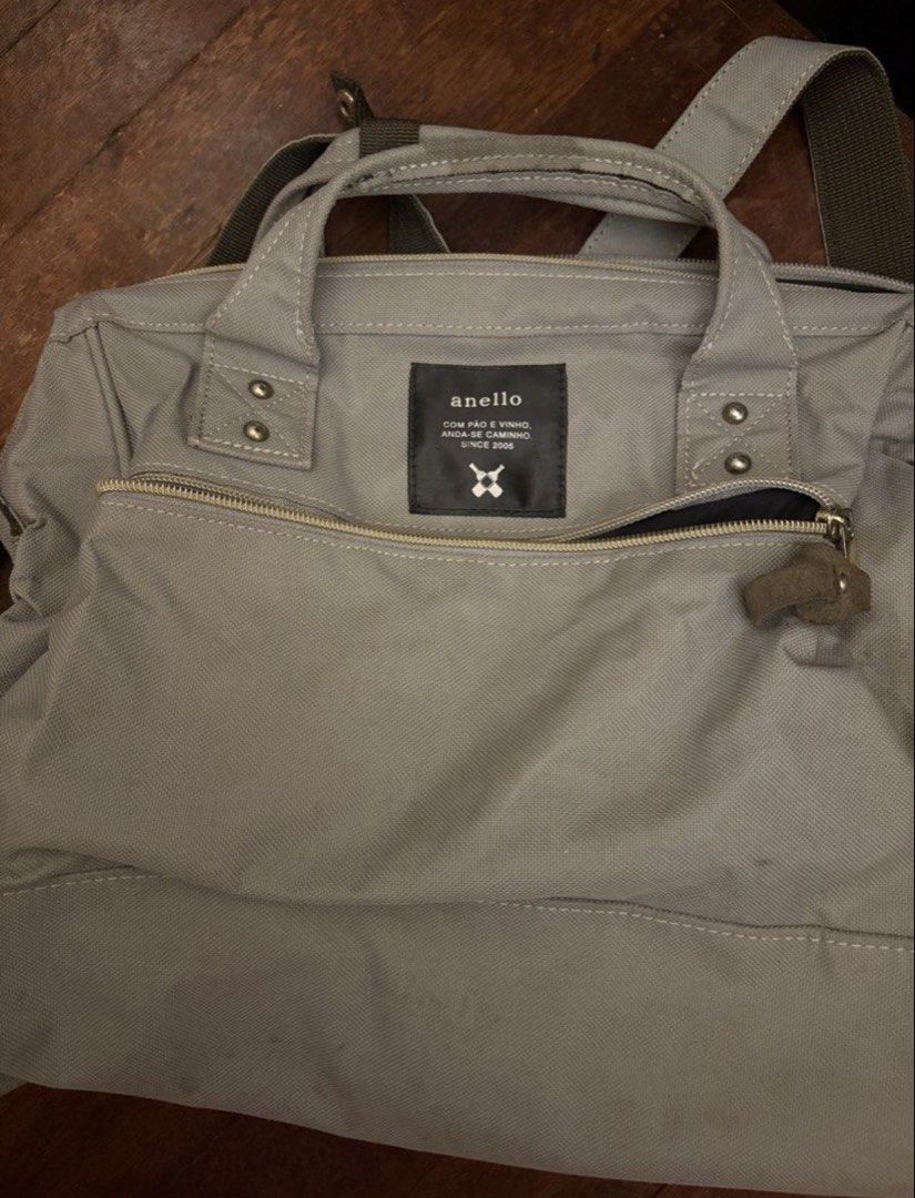 Anello Backpack Grey Canvas (Category: Backpacks) located in Manila. Submitted by z.finds (Listing ID 1460372675, Image 1). Description: - Grey Anello canvas backpack - Versatile carrying options: top handles and adjustable shoulder strap - Convenient front zipper pocket for quick access - Spacious interior, perfect for daily use - Interior label reads: 'anello COM PÃO E VINHO, ANDA-SE CAMINHO. SINCE 2005'.