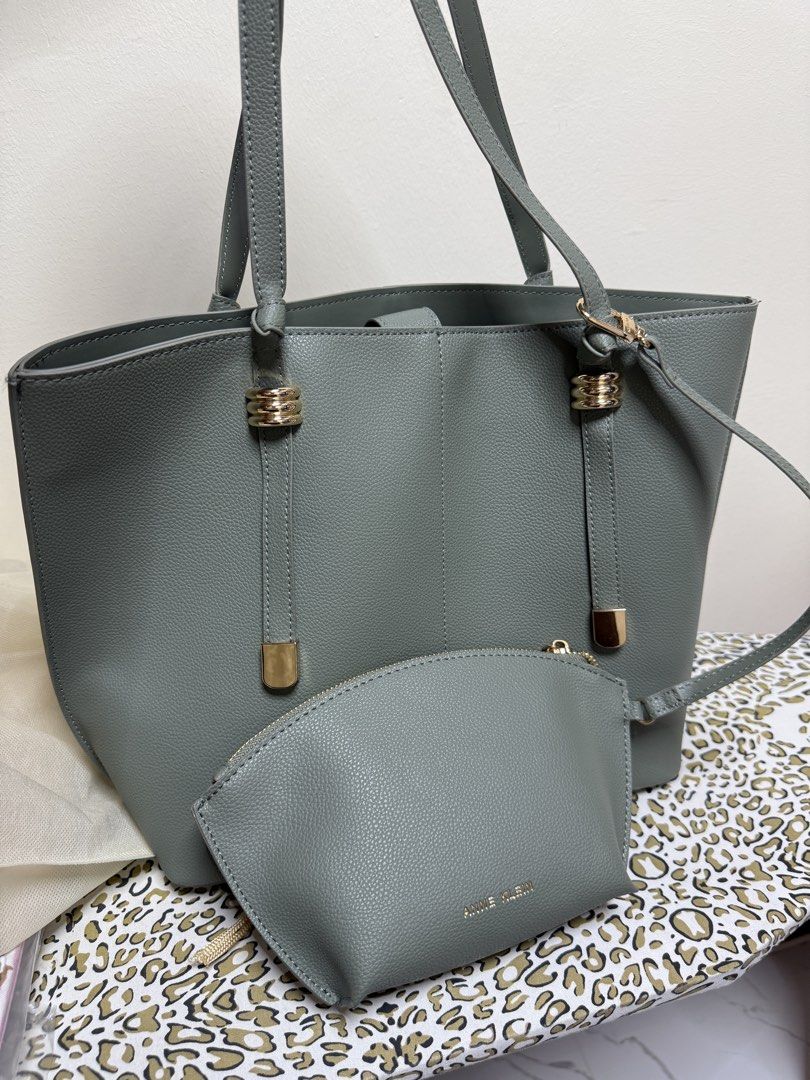 Anne Klein Grey Tote Bag with Matching Pouch (Category: Tote Bags) located in Quezon City. Submitted by samutsariatpb (Listing ID 1460445598, Image 1). Description: - Anne Klein grey tote bag - Includes a smaller matching pouch - Structured base for stability - Elegant gold hardware details - Spacious interior for all your essentials - Ideal for everyday use or travel - Pouch is perfect for organizing smaller items.