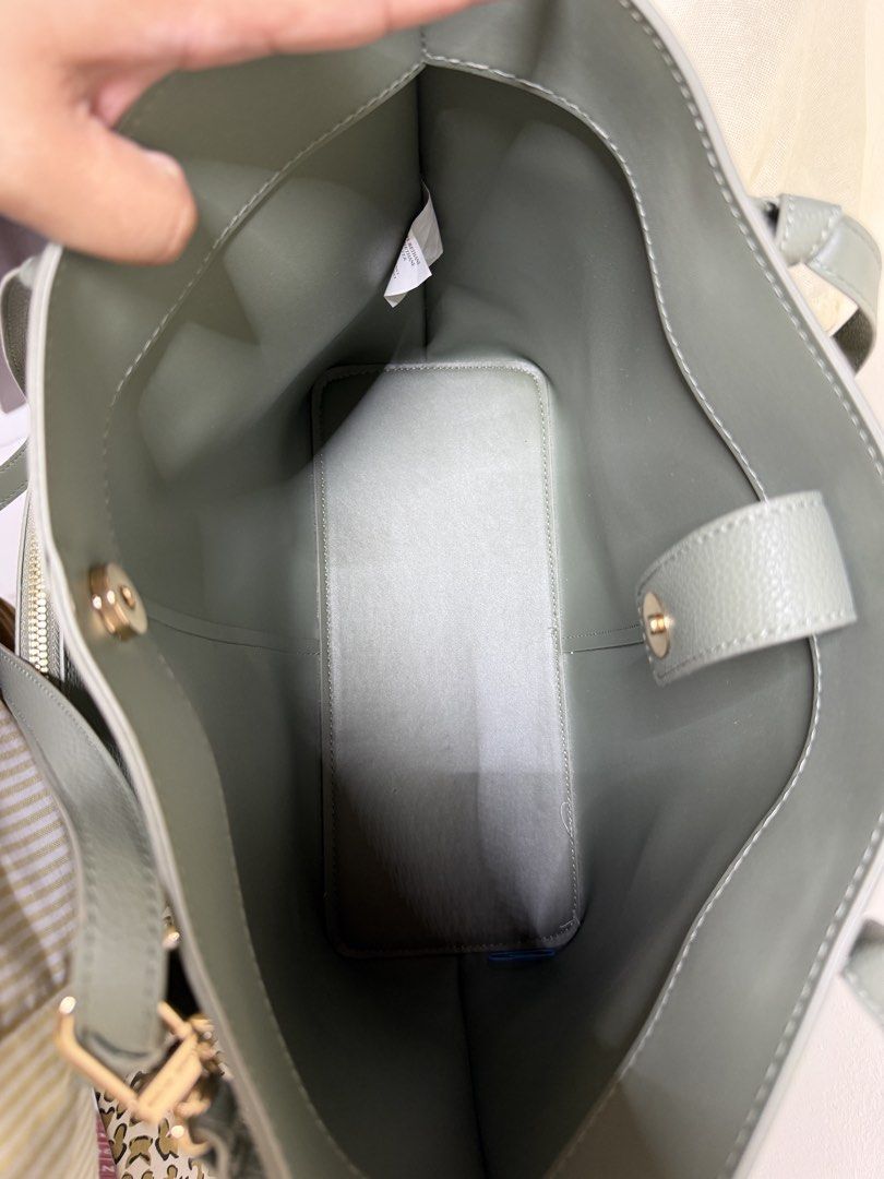Anne Klein Grey Tote Bag with Matching Pouch (Category: Tote Bags) located in Quezon City. Submitted by samutsariatpb (Listing ID 1460445598, Image 3). Description: - Anne Klein grey tote bag - Includes a smaller matching pouch - Structured base for stability - Elegant gold hardware details - Spacious interior for all your essentials - Ideal for everyday use or travel - Pouch is perfect for organizing smaller items.