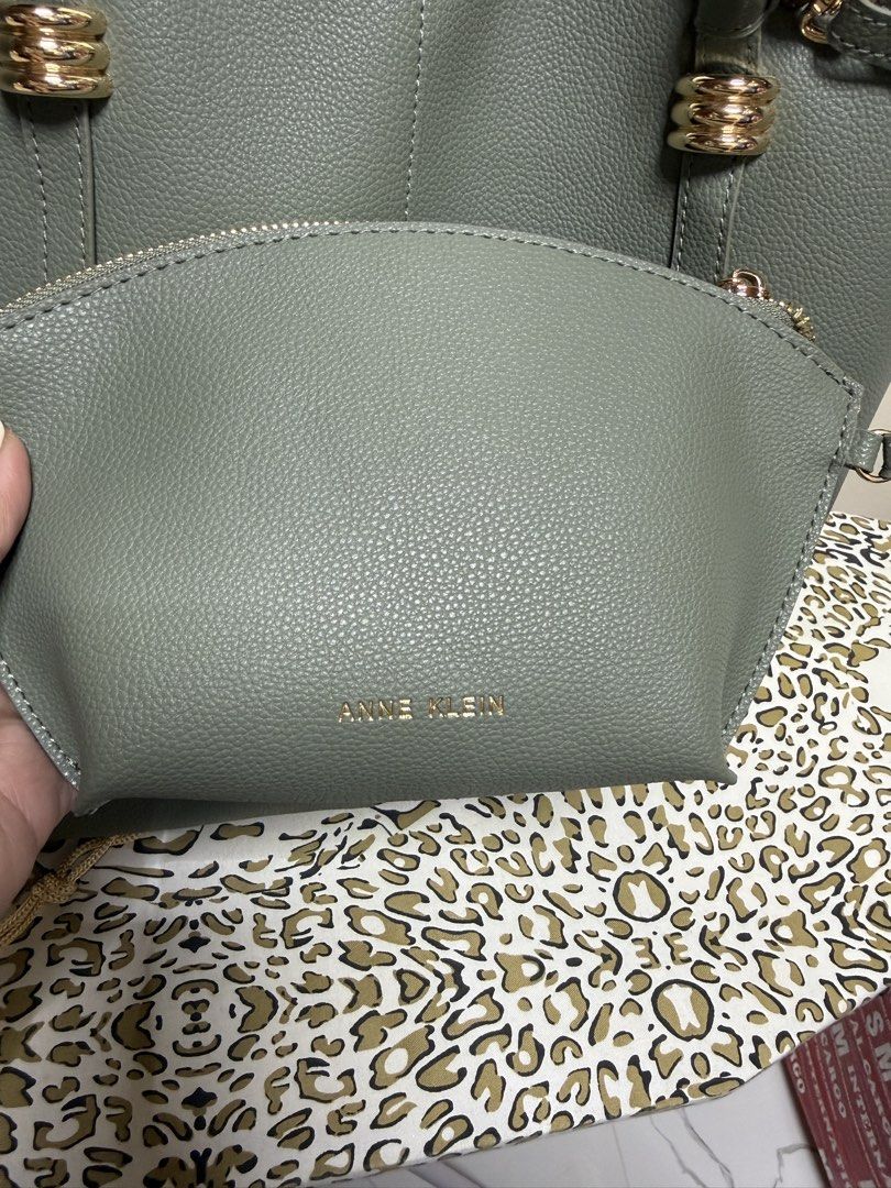 Anne Klein Grey Tote Bag with Matching Pouch (Category: Tote Bags) located in Quezon City. Submitted by samutsariatpb (Listing ID 1460445598, Image 2). Description: - Anne Klein grey tote bag - Includes a smaller matching pouch - Structured base for stability - Elegant gold hardware details - Spacious interior for all your essentials - Ideal for everyday use or travel - Pouch is perfect for organizing smaller items.