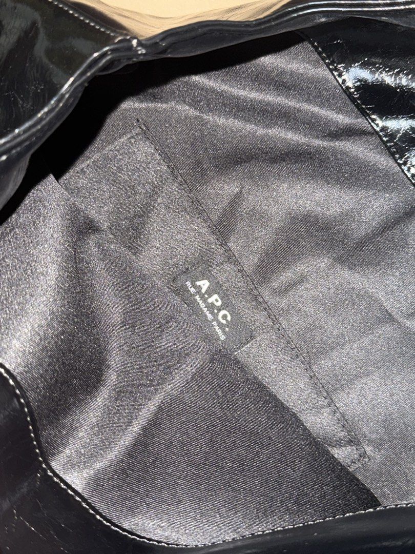A.P.C. Ninon Tote Bag (Glossy) (Category: Shoulder Bags) located in Manila. Submitted by ivl.shop (Listing ID 1460445550, Image 3). Description: Decluttering a barely used A.P.C. black glossy leather tote bag. It easily fits a MacBook Air and an iPad while keeping a sleek, stylish look for the office. Selling simply because it is a bit too large for my daily work bag. • Material: Black Lether (glossy) • Dimensions: 45 x 35.5 x 14 cm • Design: Fea