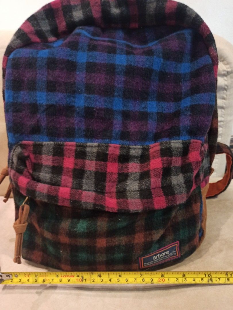 Arbore Plaid Flannel Backpack mixed color design (Category: Backpacks) located in Caloocan City. Submitted by rtarellano (Listing ID 1460434388, Image 2). Description: - Stylish plaid flannel backpack in blue, red, purple, and green checks. - Accented with durable brown leather details and straps. - Bright and fun orange interior lining. - Ideal for everyday adventures or your next getaway..