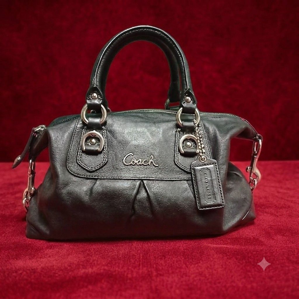 Coach Leather Satchel Bag (Category: Purses & Pouches) located in Cagayan de Oro. Submitted by susanthrifts (Listing ID 1460447945, Image 2). Description: ​Brand & Model: Coach (Serial No. D1275-F18445) ​Material: Black full-grain cowhide leather with purple satin interior ​Hardware: Silver-tone hardware with original leather hangtag and IDEAL zippers ​Condition: Pre-loved; leather and exterior in great shape, minor inner lining stains from norma