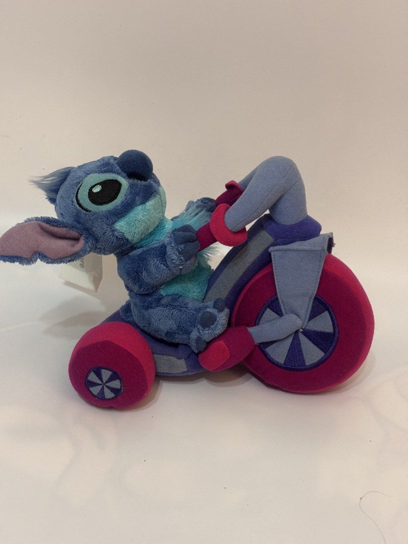 Authentic Disney Store Stitch on Tricycle Plush (Category: Plushies & Soft Toys) located in Antipolo. Submitted by bhabiegraciefashionlab (Listing ID 1460506079, Image 3). Description: Selling an authentic Disney Store Stitch on Tricycle plush in excellent, brand-new condition with the original tag still attached! Character: Stitch (from Lilo & Stitch)Features: Stitch is riding a colorful plush tricycle (blue, purple, and bright pink). Condition: