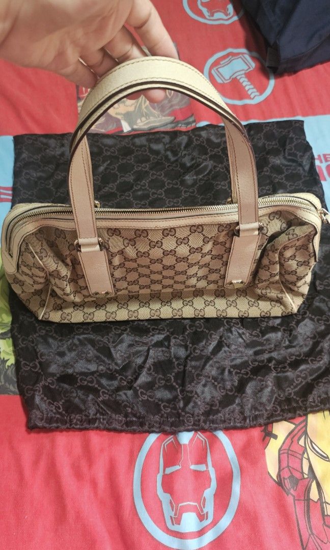 Authentic Gucci GG Canvas Shoulder bag (Category: Luxury Bags & Wallets) located in Manila. Submitted by fanta0923 (Listing ID 1460327317, Image 2). Description: ✨ Authentic Gucci GG Canvas Shoulder Bag — Beige/White ✨ Classic vintage Gucci satchel — retired style, timeless design. GG monogram canvas with white leather trim, silver stud hardware, top zip closure. Good condition — canvas clean, leather supple, interior fresh. Serial number intact 