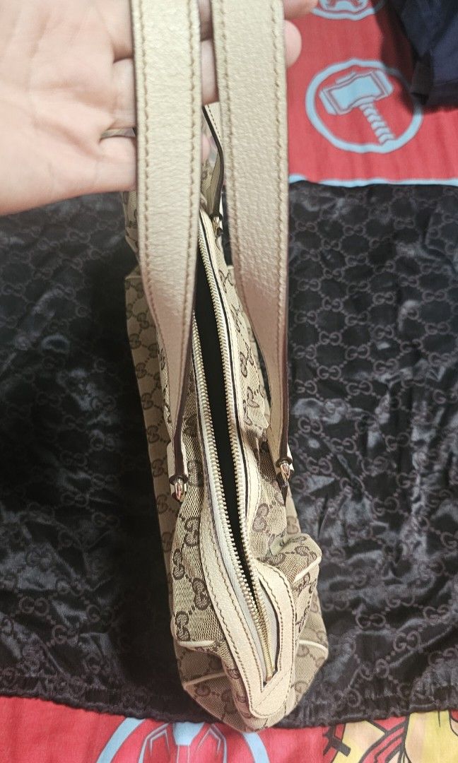 Authentic Gucci GG Canvas Shoulder bag (Category: Luxury Bags & Wallets) located in Manila. Submitted by fanta0923 (Listing ID 1460327317, Image 3). Description: ✨ Authentic Gucci GG Canvas Shoulder Bag — Beige/White ✨ Classic vintage Gucci satchel — retired style, timeless design. GG monogram canvas with white leather trim, silver stud hardware, top zip closure. Good condition — canvas clean, leather supple, interior fresh. Serial number intact 
