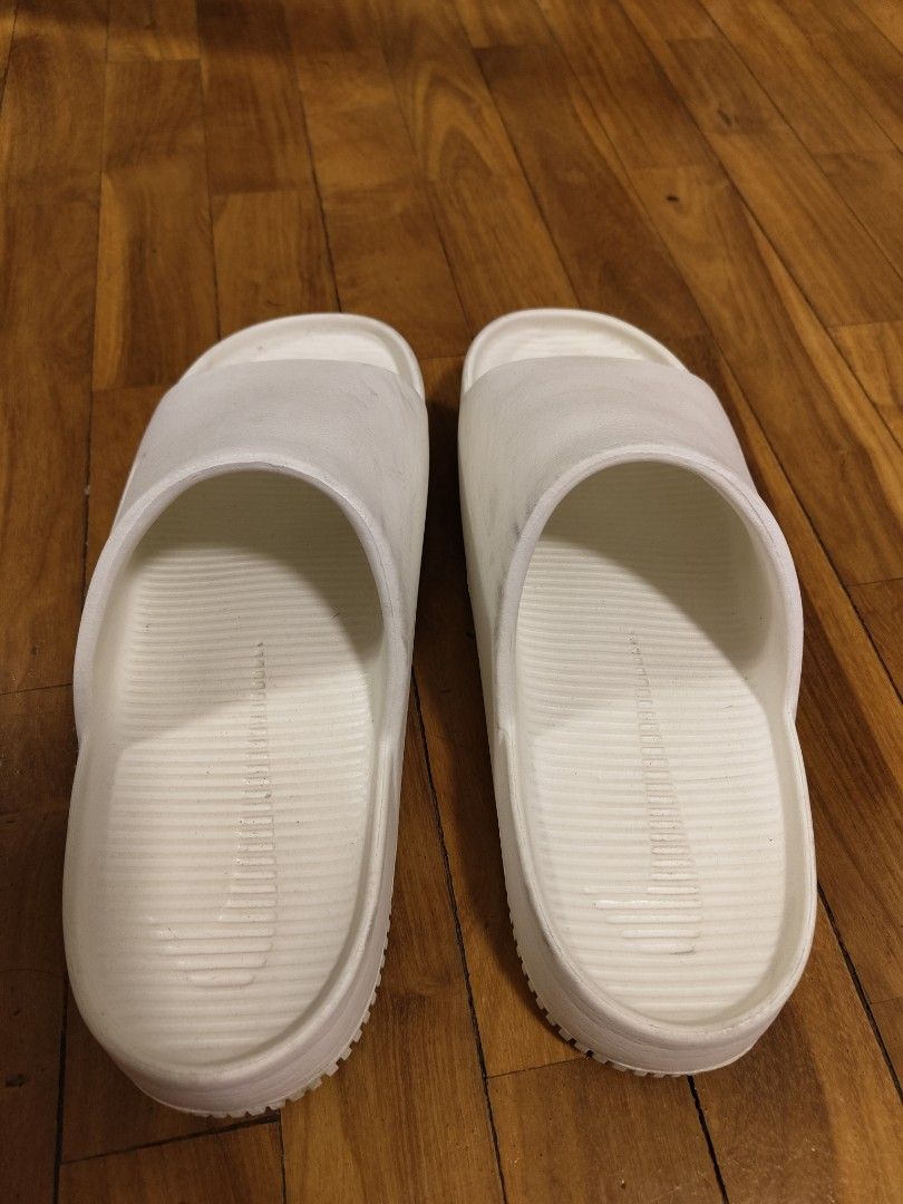 Authentic Nike Slides (Category: Slippers & Slides) located in Makati City. Submitted by kfcalderon926 (Listing ID 1460447537, Image 2). Description: seldom used authentic Nike Slides color: white has some dirt but no major flaws size: M 11 / W 12 Rfs: decluttering MOP: BPI/Gcash/ Gotyme delivery: via Grab or Lalamove ONLY. sf c/o. buyer Location: Makati.