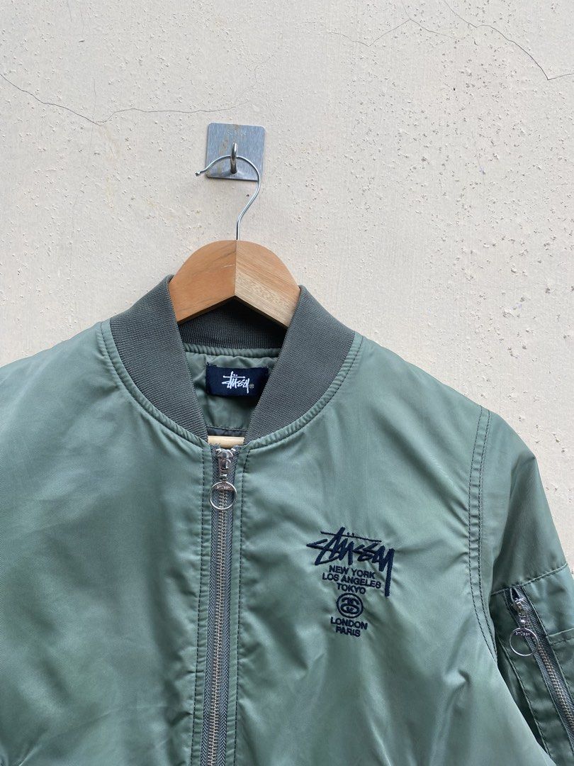 Authentic Stussy bomber jacket (Category: Coats, Jackets and Outerwear) located in Manila. Submitted by swordthrift (Listing ID 1460420240, Image 2). Description: - Authentic Stussy bomber jacket - Dimes: 20x20 - Features ‘Stussy World Tribe’ graphic on the back - Unique patches on sleeves: tiger, roses, and more - Zipper closure with convenient pockets - Ribbed collar, cuffs, and hem for a classic fit - Estimated size: 8 (please check measuremen