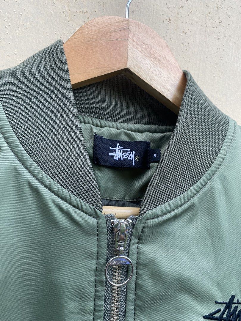 Authentic Stussy bomber jacket (Category: Coats, Jackets and Outerwear) located in Manila. Submitted by swordthrift (Listing ID 1460420240, Image 3). Description: - Authentic Stussy bomber jacket - Dimes: 20x20 - Features ‘Stussy World Tribe’ graphic on the back - Unique patches on sleeves: tiger, roses, and more - Zipper closure with convenient pockets - Ribbed collar, cuffs, and hem for a classic fit - Estimated size: 8 (please check measuremen