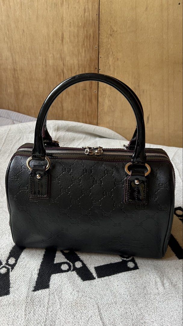 Balenciaga Black Monogrammed Boston Bag (Category: Luxury Bags & Wallets) located in Cagayan de Oro. Submitted by nelsondel21723 (Listing ID 1460315212, Image 2). Description: - Authentic Black Balenciaga Boston Bag - Signature all-over monogram pattern - Unique snakeskin and metallic stripe detail on the front - Luxurious patent leather handles - Secure zipper closure - Four protective metal feet on the bottom - Ideal for stylish everyday use.