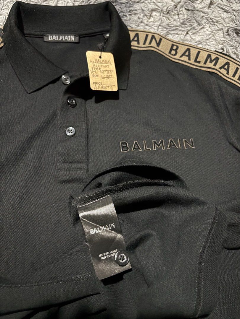 BALMAIN (Category: Luxury Apparel) located in Legazpi City. Submitted by thesource052 (Listing ID 1460494722, Image 3). Description: Balmain polo shirt featuring branded shoulder tape with repeated “BALMAIN” lettering in a contrasting tone and an embroidered Balmain logo on the chest. Bought for 33K PHP AT DUBAI. Used 1x only Medium on tag but fits to large Width: 20-21.5” stretchable Length: 28” .