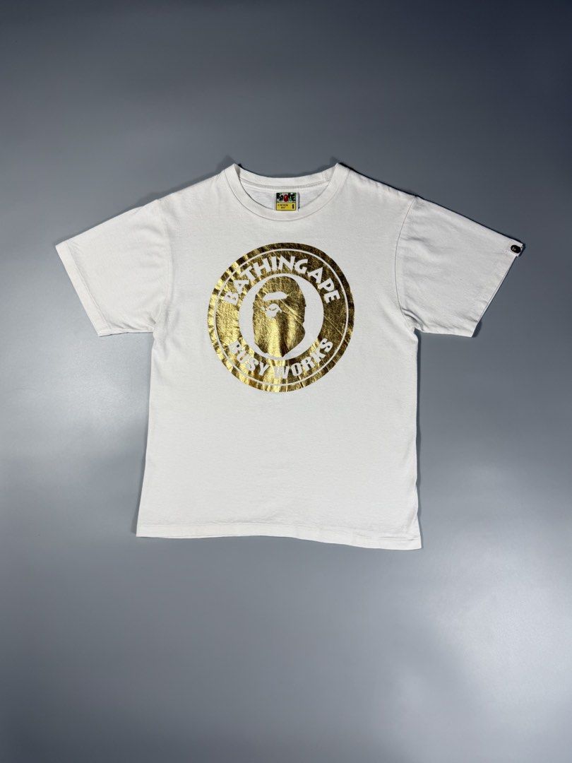 Bape Busy Works Gold Circle Logo Tee White (Category: Tshirts & Polo Shirts ) located in Manila. Submitted by whowearsstreetwear (Listing ID 1460482941, Image 1). Description: Bape Busy Works Gold Circle Logo Tee White (Authentic) - Size: Small on tag (measurements in inches) W - 19 L - 25 Condition: Excellent Flaw/s: minor stain only + shipping fee Location: Manila (Near UST).