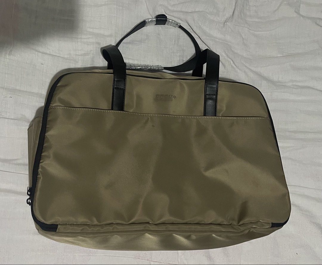 BASH Duffle Bag - Khaki Nylon with Black Trim (Category: Shoulder Bags) located in Cabanatuan. Submitted by anhsiacheng (Listing ID 1460502109, Image 1). Description: - Brand: BASH Gateway Weekender (Big size) - Color: Oak - Material: Nylon with black faux leather handles and trim - Features: Main zippered compartment, internal mesh pockets - Condition: Used but in good condition (handles still wrapped in plastic) - Ideal for: Travel, gym bag - C