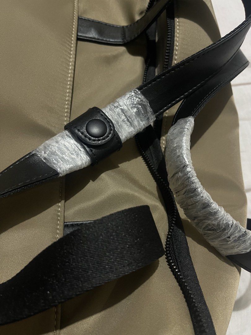 BASH Duffle Bag - Khaki Nylon with Black Trim (Category: Shoulder Bags) located in Cabanatuan. Submitted by anhsiacheng (Listing ID 1460502109, Image 2). Description: - Brand: BASH Gateway Weekender (Big size) - Color: Oak - Material: Nylon with black faux leather handles and trim - Features: Main zippered compartment, internal mesh pockets - Condition: Used but in good condition (handles still wrapped in plastic) - Ideal for: Travel, gym bag - C