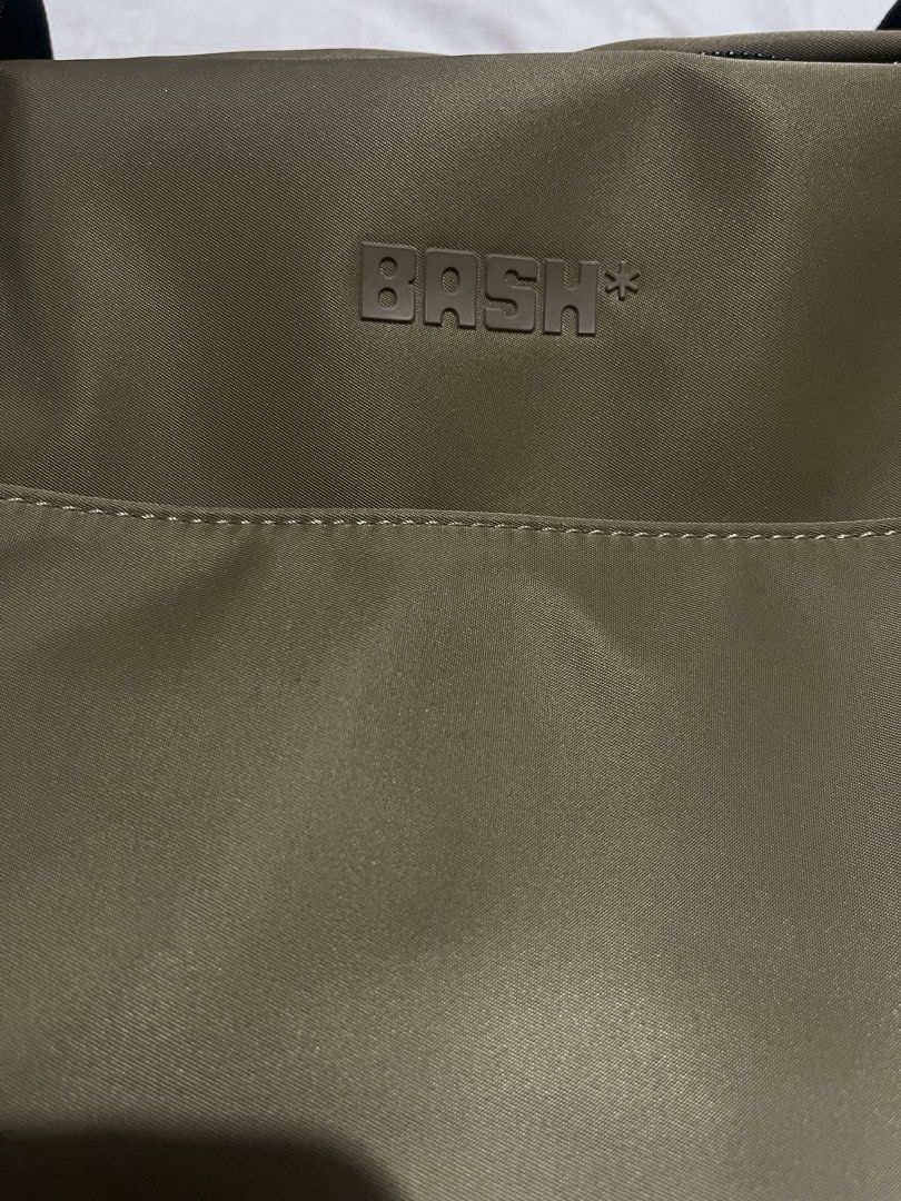 BASH Duffle Bag - Khaki Nylon with Black Trim (Category: Shoulder Bags) located in Cabanatuan. Submitted by anhsiacheng (Listing ID 1460502109, Image 3). Description: - Brand: BASH Gateway Weekender (Big size) - Color: Oak - Material: Nylon with black faux leather handles and trim - Features: Main zippered compartment, internal mesh pockets - Condition: Used but in good condition (handles still wrapped in plastic) - Ideal for: Travel, gym bag - C