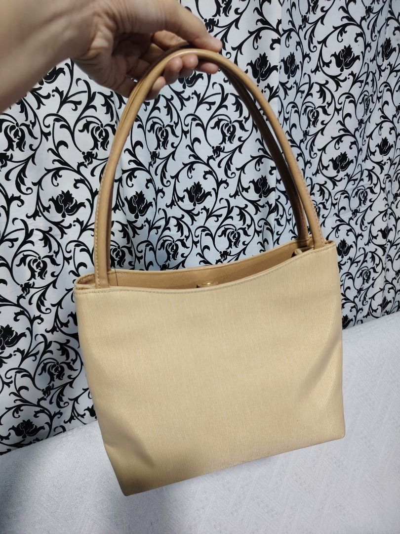 Beige Shoulder Bag with Tan Straps (Category: Shoulder Bags) located in Manila. Submitted by theshopandsmile (Listing ID 1460444023, Image 2). Description: - Classic beige shoulder bag - Tan leather straps - Simple and chic design - Gold hardware details - Perfect for everyday use - Ample interior space - Versatile accessory for any outfit - Easy to carry.