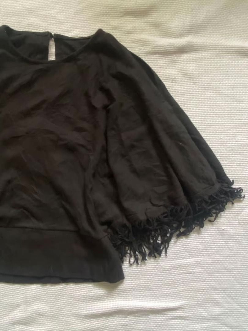 Black batwing top (Category: Others Tops) located in Cebu City. Submitted by just_pingkyle (Listing ID 1460448457, Image 2). Description: - Chic black cape top - Flowy, loose fit - Eye-catching fringe detail along the hem - Convenient keyhole closure at the back neck - Perfect for layering or as a standalone piece - Effortlessly transitions from casual to dressy outfits.