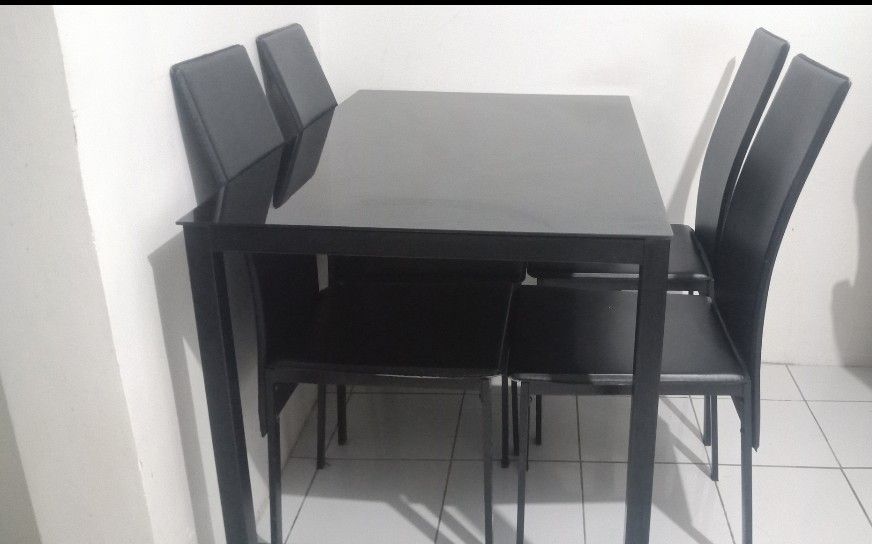 Black Glass Top Dining Table with 4 Chairs (Category: Tables & Sets) located in Manila. Submitted by rayannange07114 (Listing ID 1460330315, Image 3). Description: CAVITE AREA - Sleek black glass top dining table - Includes 4 matching black chairs - Modern and stylish design - Comfortable seating for 4 people - Ideal for small dining areas or kitchens - Easy to clean glass surface - Sold as a complete set May issue lang isa upuan medyo nagewang n