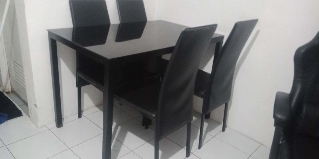 Black Glass Top Dining Table with 4 Chairs (Category: Tables & Sets) located in Manila. Submitted by rayannange07114 (Listing ID 1460330315, Image 2). Description: CAVITE AREA - Sleek black glass top dining table - Includes 4 matching black chairs - Modern and stylish design - Comfortable seating for 4 people - Ideal for small dining areas or kitchens - Easy to clean glass surface - Sold as a complete set May issue lang isa upuan medyo nagewang n
