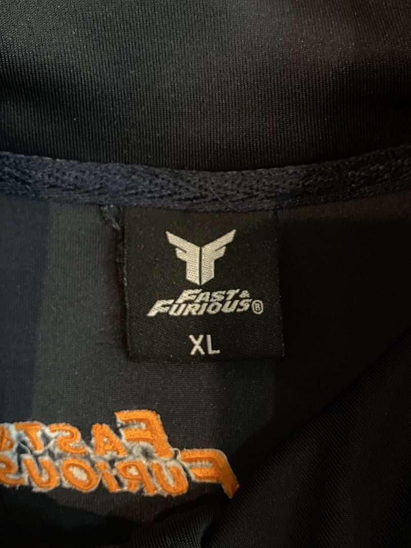 Black Jacket with Orange Logo (Category: Coats, Jackets and Outerwear) located in Manila. Submitted by sebthrift (Listing ID 1460370510, Image 2). Description: - Black jacket with a unique ribbed texture. - Features a vibrant orange logo on the chest. - Versatile for casual outings or athletic activities..