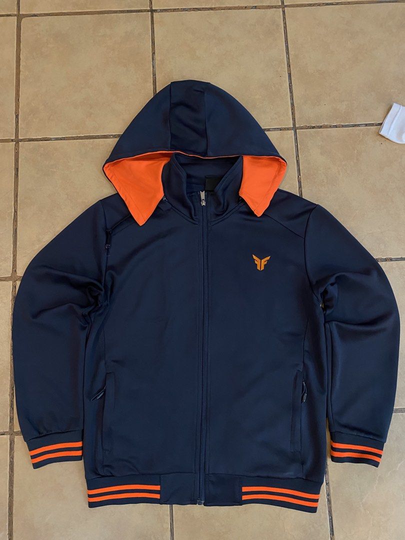 Black Jacket with Orange Logo (Category: Coats, Jackets and Outerwear) located in Manila. Submitted by sebthrift (Listing ID 1460370510, Image 1). Description: - Black jacket with a unique ribbed texture. - Features a vibrant orange logo on the chest. - Versatile for casual outings or athletic activities..