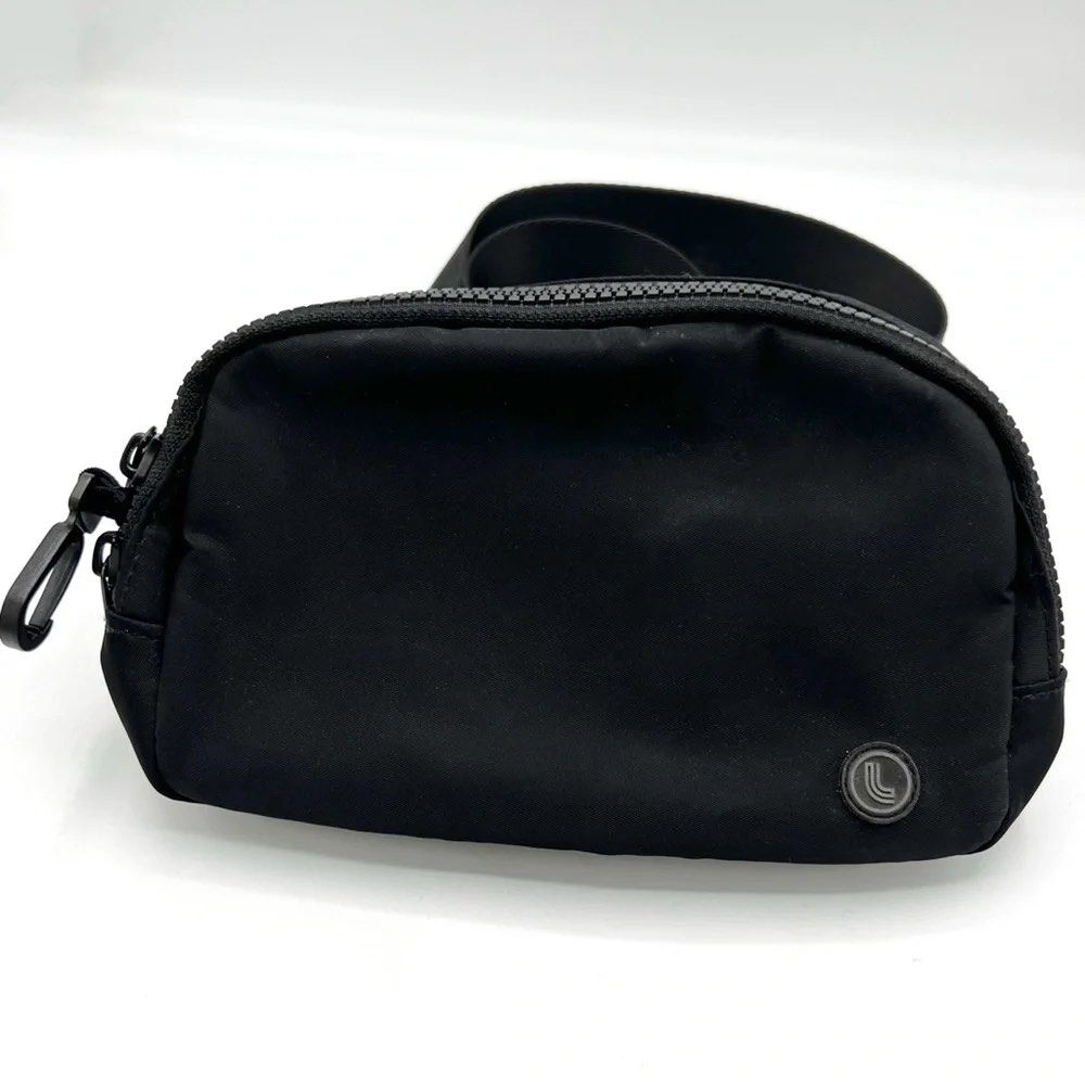 Black Lolë belt bag (Category: Cross-body Bags) located in Manila. Submitted by madecuratedwithlove11 (Listing ID 1460471379, Image 2). Description: - Brand: Lole - Model: Everywhere Belt Bag - Color: Black - Material: Nylon - Features: Adjustable strap with Lululemon logo, zipper closure - Use: Ideal for everyday or travel - Capacity: Ample space for essentials.