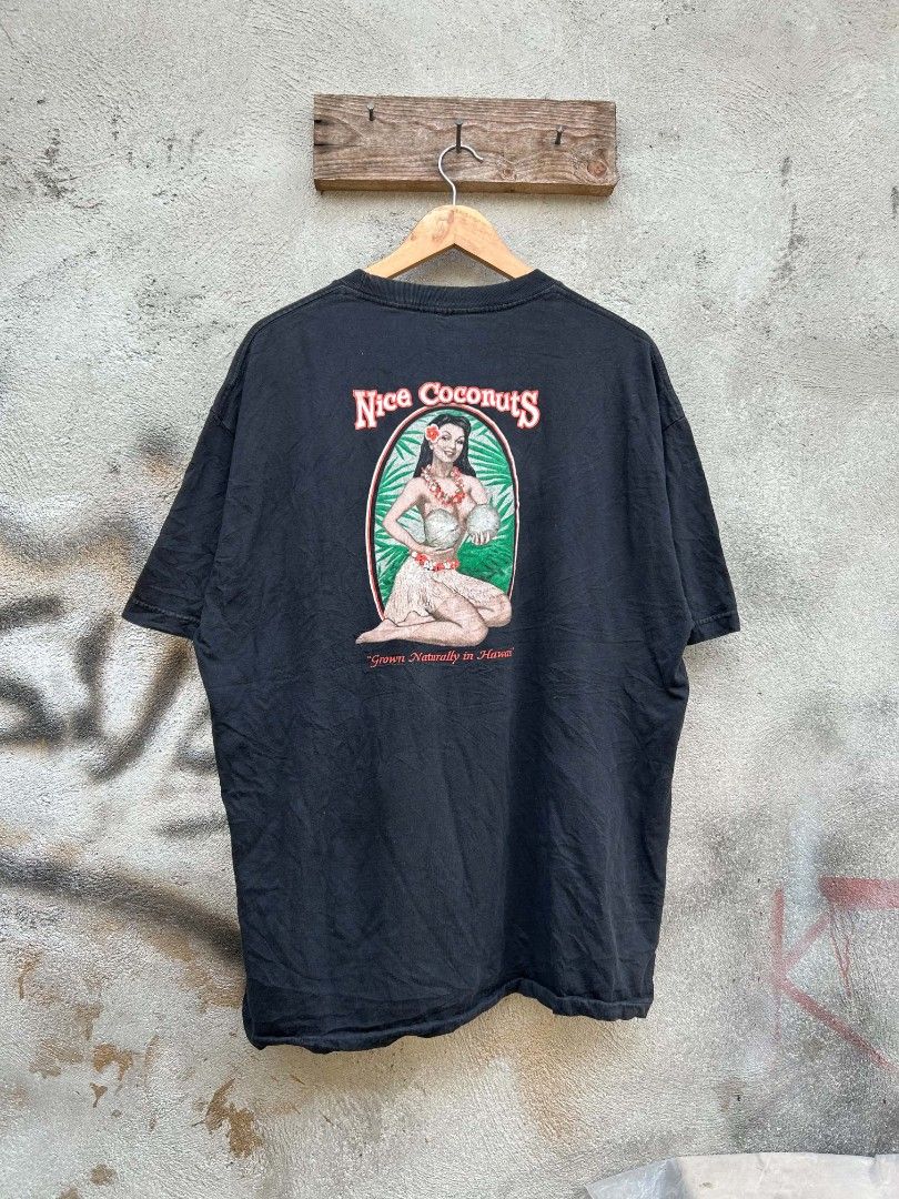 Black "Nice Coconuts" Hawaiian Graphic T-Shirt (Category: Tshirts & Polo Shirts ) located in Polomolok. Submitted by joshualusa62716 (Listing ID 1460322668, Image 1). Description: - Black t-shirt - "Nice Coconuts" graphic on back: hula girl, coconuts, "Grown Naturally in Hawaii" - Small "Nice Coconuts Maui-Hawaii-Kauai" graphic on front - Ideal for casual wear and tropical vibes.