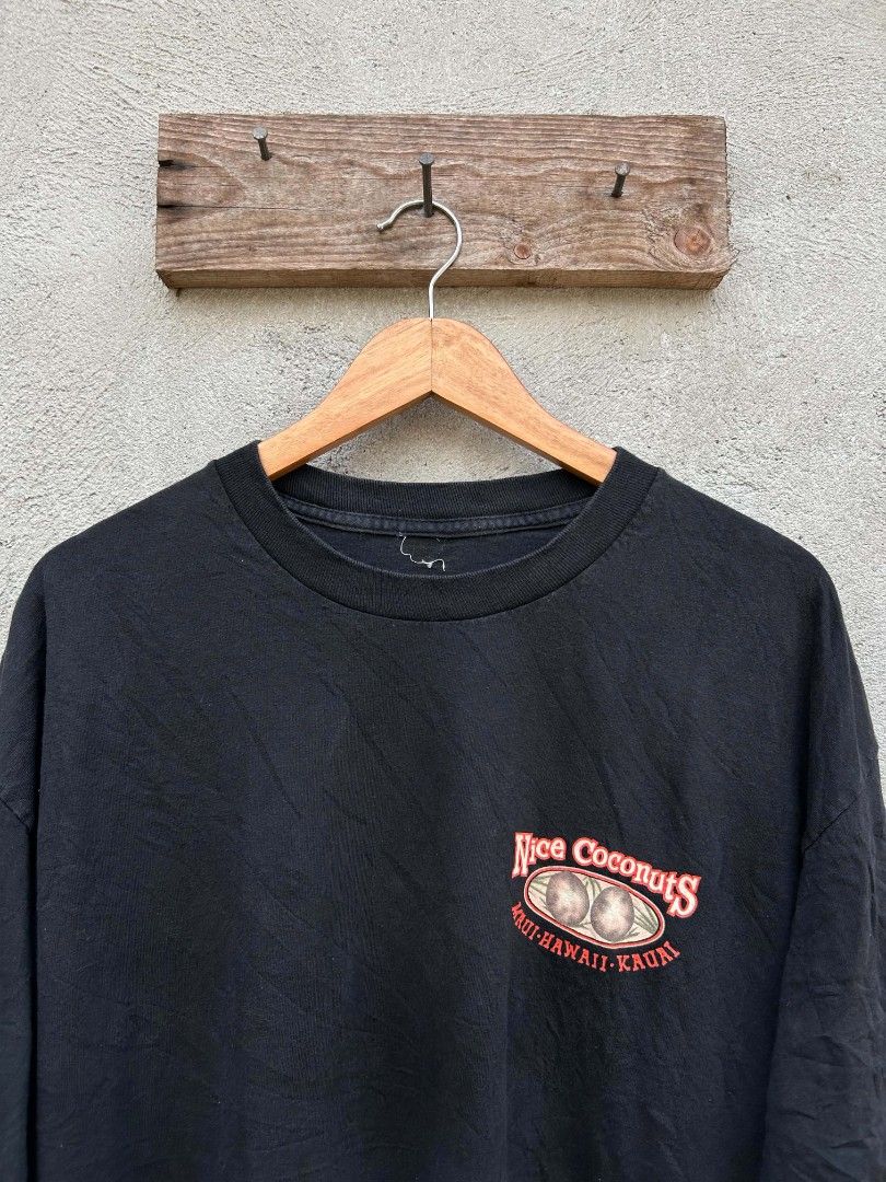 Black "Nice Coconuts" Hawaiian Graphic T-Shirt (Category: Tshirts & Polo Shirts ) located in Polomolok. Submitted by joshualusa62716 (Listing ID 1460322668, Image 3). Description: - Black t-shirt - "Nice Coconuts" graphic on back: hula girl, coconuts, "Grown Naturally in Hawaii" - Small "Nice Coconuts Maui-Hawaii-Kauai" graphic on front - Ideal for casual wear and tropical vibes.