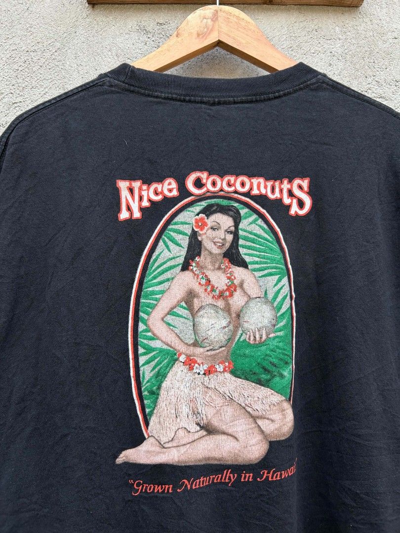 Black "Nice Coconuts" Hawaiian Graphic T-Shirt (Category: Tshirts & Polo Shirts ) located in Polomolok. Submitted by joshualusa62716 (Listing ID 1460322668, Image 2). Description: - Black t-shirt - "Nice Coconuts" graphic on back: hula girl, coconuts, "Grown Naturally in Hawaii" - Small "Nice Coconuts Maui-Hawaii-Kauai" graphic on front - Ideal for casual wear and tropical vibes.