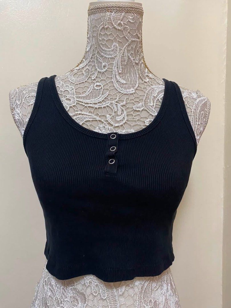 Black Ribbed Button-Up Crop Tank Top (Category: Sleeveless) located in Manila. Submitted by airamef28.closet (Listing ID 1460419517, Image 1). Description: - Black ribbed crop tank top - Scoop neckline with three small buttons - Sleeveless design - Stretchy material for comfort - Perfect for layering or wearing solo - Ideal for casual outfits.