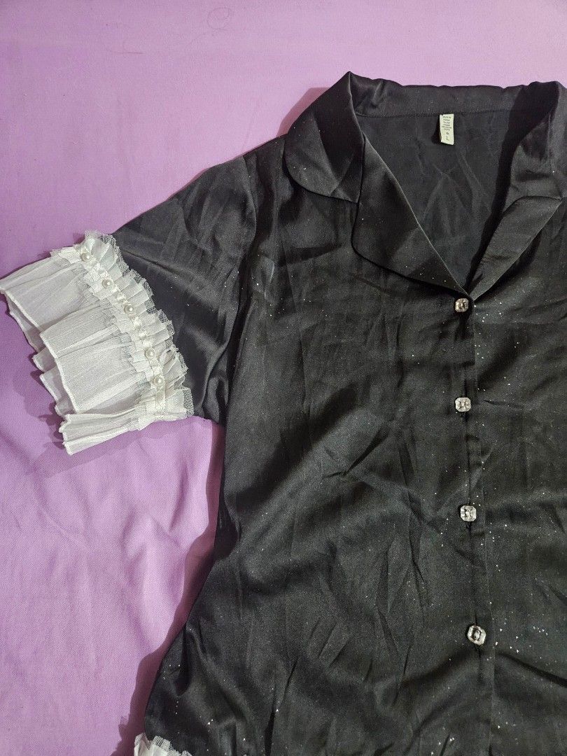 Black Ruffle-Sleeve Shimmer Blouse Top (Category: Blouses) located in Taguig. Submitted by lunabelle.thrifts (Listing ID 1460448529, Image 3). Description: ୨୧ Good condition, no issues ♡ ୨୧ Size: M–L; L on tag ୨୧ Black blouse with subtle shimmer details ୨୧ Ruffle detail along the hem and sleeves ୨୧ Already washed and ready to wear ♡ Model's measurements: ୨୧ Bust — 40" ୨୧ Underbust — 35" ୨୧ Waist — 34" ୨୧ Height — 5'6".