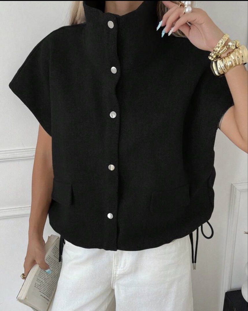 Black Sleeveless Vest with High Neck and Button-Up Front (Category: Sleeveless) located in Iloilo. Submitted by dabyladaby2 (Listing ID 1460449561, Image 1). Description: - Chic black sleeveless vest - High neckline with button-up closure - Two functional front pockets - Adjustable drawstring details on the sides - Versatile layering piece -thick fabric - shoulder 23.2in , bust 42.5 in , length 20.5 in.