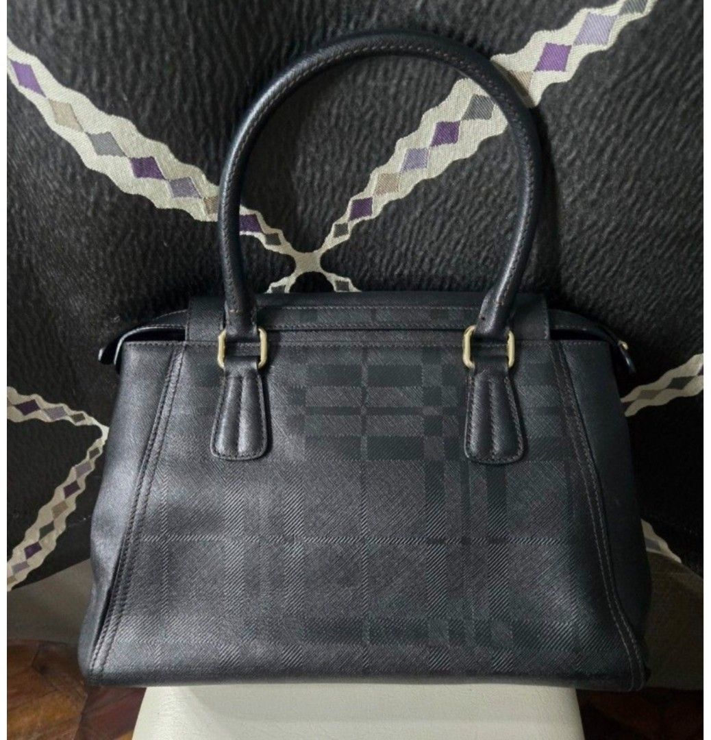 Black Textured Handbag with Gold Charm (Category: Other Accessories) located in Quezon City. Submitted by affordabags_cd (Listing ID 1460426604, Image 3). Description: - Classic black handbag with a subtle textured pattern. - Elegant gold hardware and decorative 'D' charm. - Comfortable top handles for easy carrying. - Protective gold studs on the bottom to prevent wear. - Versatile for both everyday use and special events..