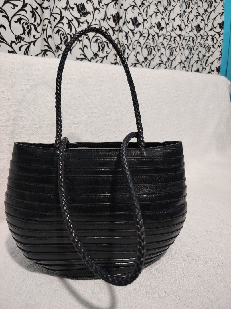 Black Textured Shoulder Bag with Braided Straps (Category: Shoulder Bags) located in Manila. Submitted by theshopandsmile (Listing ID 1460441582, Image 1). Description: - Chic black handbag with a unique textured finish. - Features stylish braided straps. - Distinctive rounded, oval silhouette. - Ideal for carrying your daily essentials. - A versatile and fashionable accessory for any outfit..