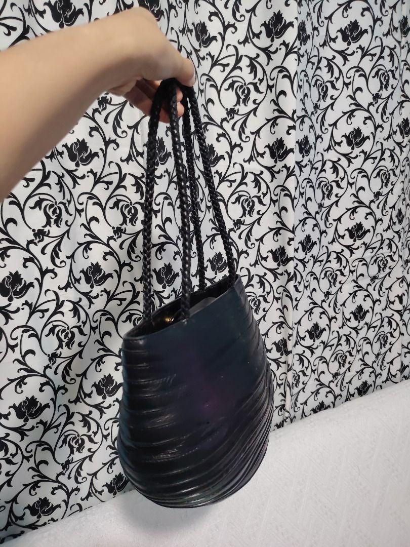Black Textured Shoulder Bag with Braided Straps (Category: Shoulder Bags) located in Manila. Submitted by theshopandsmile (Listing ID 1460441582, Image 3). Description: - Chic black handbag with a unique textured finish. - Features stylish braided straps. - Distinctive rounded, oval silhouette. - Ideal for carrying your daily essentials. - A versatile and fashionable accessory for any outfit..