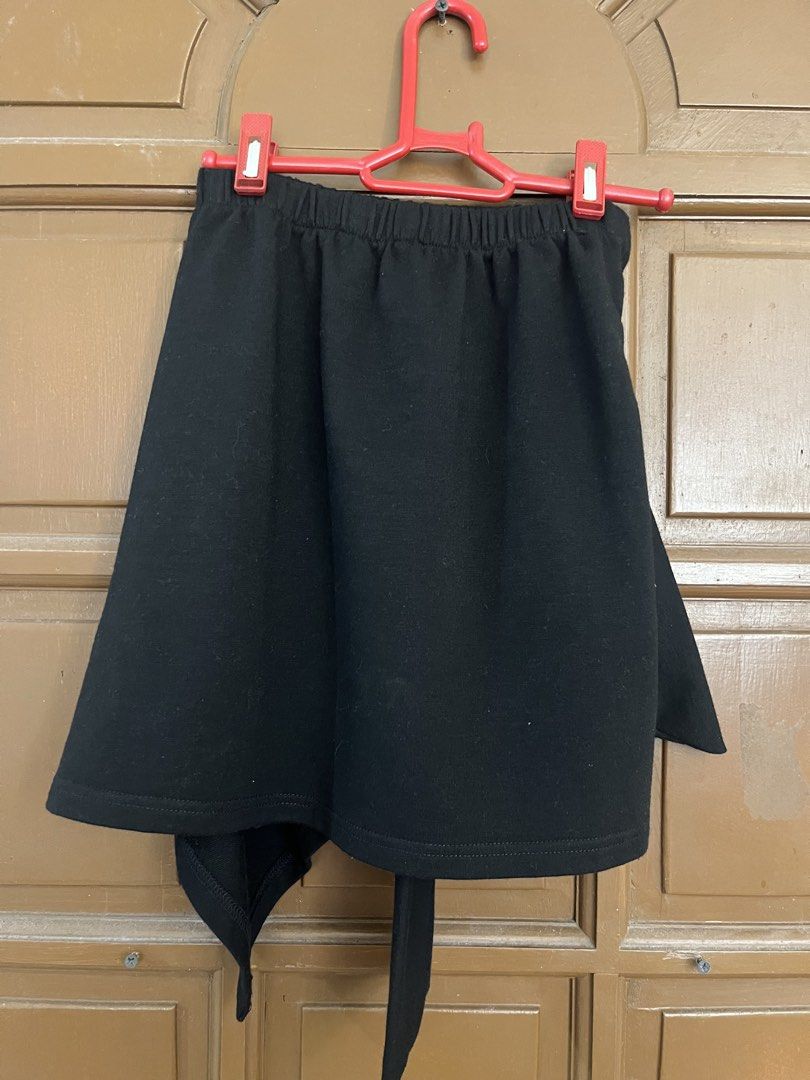 Black Wrap Skirt with Tie Detail (Category: Skirts) located in Manila. Submitted by ellesmr122 (Listing ID 1460323331, Image 2). Description: - Versatile black wrap skirt - Comfortable elastic waistband - Adjustable front tie detail - Trendy asymmetrical hemline - Effortlessly stylish for casual or dressed-up looks.