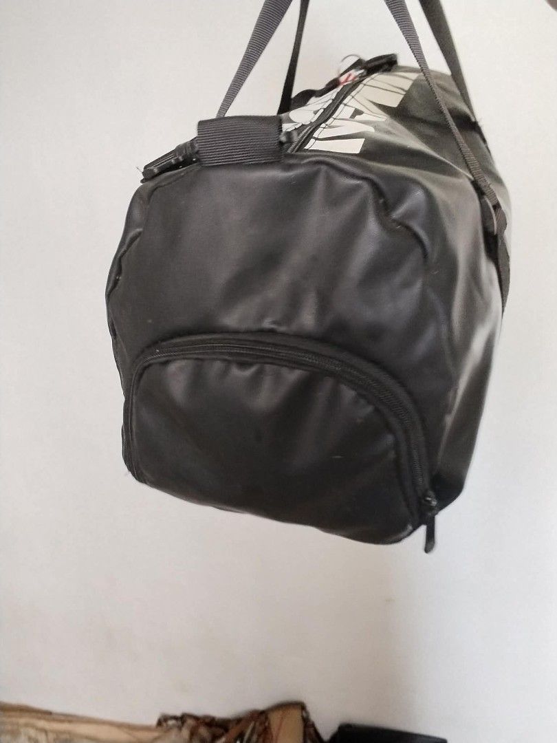 Black Xingqu Duffel Bag with Shoulder Strap (Category: Sling Bags) located in Manila. Submitted by bagelyascollection (Listing ID 1460465478, Image 2). Description: - Black duffel bag with 'XINGQU' logo - Top handles and detachable shoulder strap - Zippered main compartment - Front zippered pocket - Mesh side pocket - Ideal for gym or travel - Note: Minor scuffs on material.