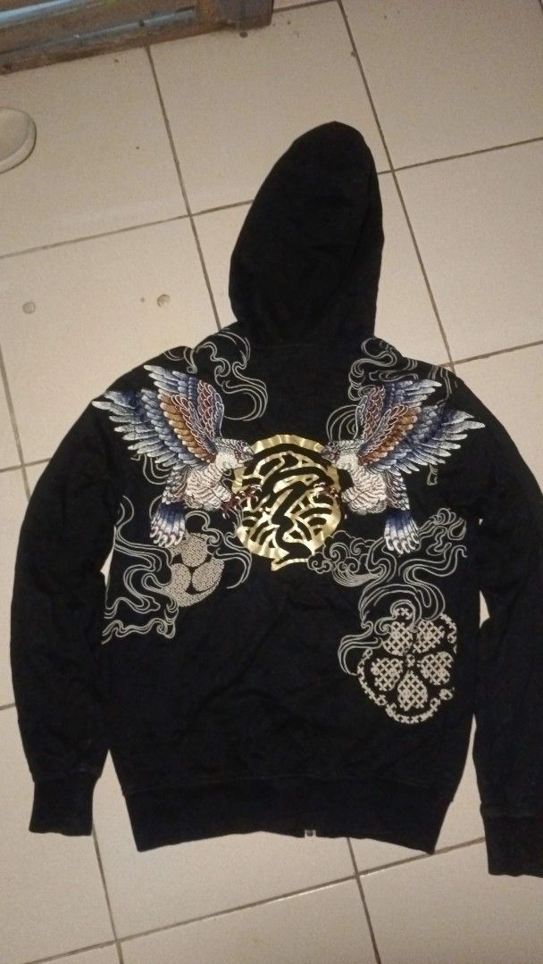 Black Zip-Up Hoodie with Eagle Embroidery (Category: Coats, Jackets and Outerwear) located in Kapatagan. Submitted by corsethrift (Listing ID 1460434448, Image 1). Description: - Black zip-up hoodie - Detailed eagle embroidery on back with gold accents - Embroidery on front left chest - Long sleeves with ribbed cuffs - Full zip closure - Ideal for casual wear.