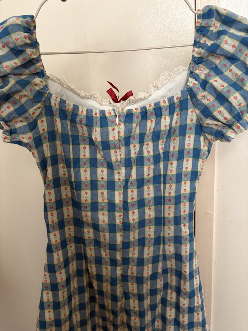 Blue Gingham Puff Sleeve Dress with Red Bow (Category: Dresses) located in Manila. Submitted by z.finds (Listing ID 1460371822, Image 3). Description: - Adorable blue gingham dress - Sweetheart neckline - Puff sleeves with a small red bow detail - Shirring on the sides for a flattering, adjustable fit - Zipper closure at the back - Perfect for picnics, casual outings, or a cute day out.